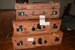 A set of three brown leather suitcases by Giovanni, largest 76cm wide, the smallest case with