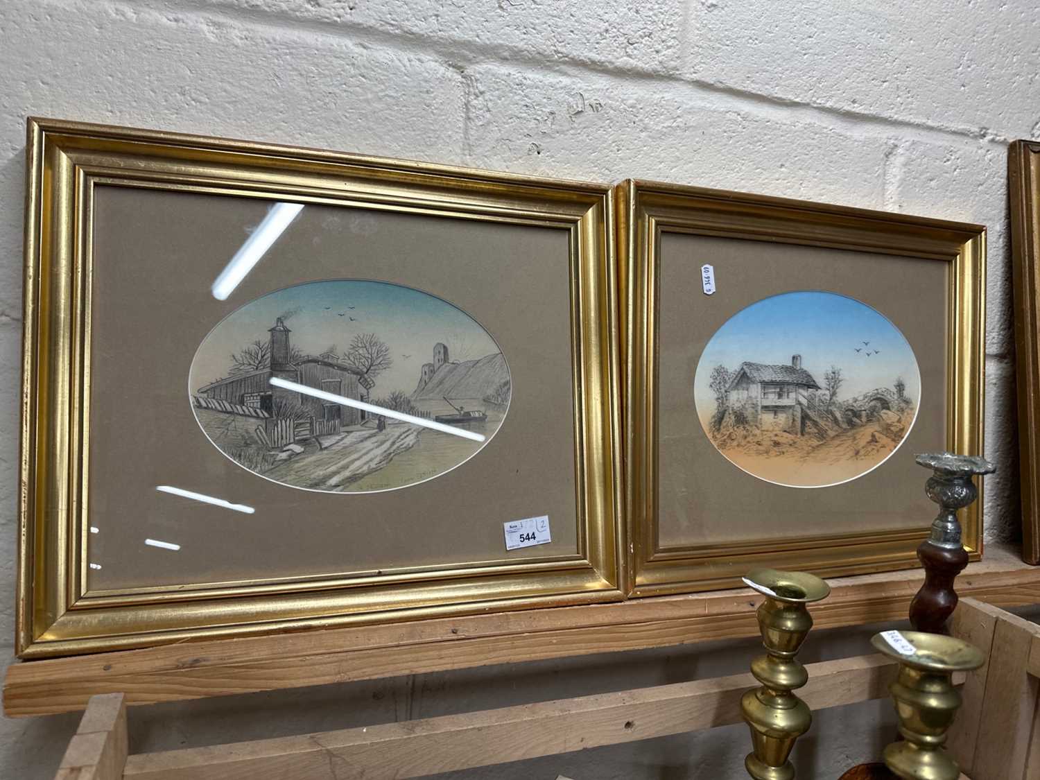 A pair of oval landscapes, framed and glazed