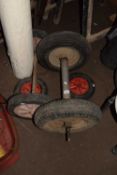 Two sets of trailer wheels on chassis and another pair of wheels