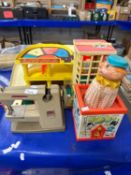 A Fisher Price garage, sewing machine and a jack in the box