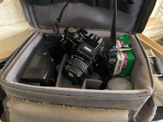 A Pentax camera with accessories and carry case