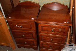 A pair of three drawer bedside cabinets