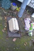 Metal dog cage, plastic pet carrier and a broomhead (3)
