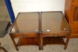 Pair of reproduction mahogany glass topped bedside tables