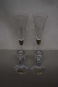 Pair of crystal glass candlesticks together with a pair of long stemmed champagne flutes, hallmarked