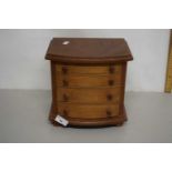 Small bow front four drawer table top chest