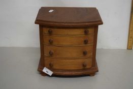 Small bow front four drawer table top chest