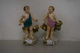 A pair of porcelain cherub figures with pseudo gold anchor marks