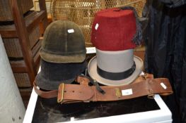 Hats to include two riding hats, top hat, a fez and leather belts