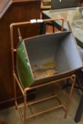 Vintage lawn mower grass box mounted on a copper frame to form a retro ice bucket