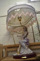 Italian lamp modelled as a lady playing a harp with beaded shade