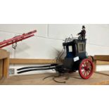 A scratch built model of a Victorian carriage painted in black with red wheels together with a