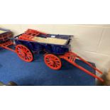 Wooden scratch built model of a Sussex Wagon, painted in red, blue and black, approx 85cm long