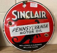 A reproduction circular enamelled sign for "Sinclair Pennsylvania Motor Oil"