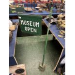 Metal and wooden sign marked 'Museum open'