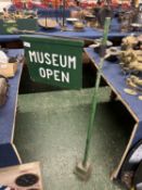 Metal and wooden sign marked 'Museum open'