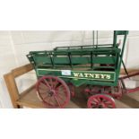 A scratch built model of a Brewery dray cart marked Watneys, painted in green and red, approx 60cm