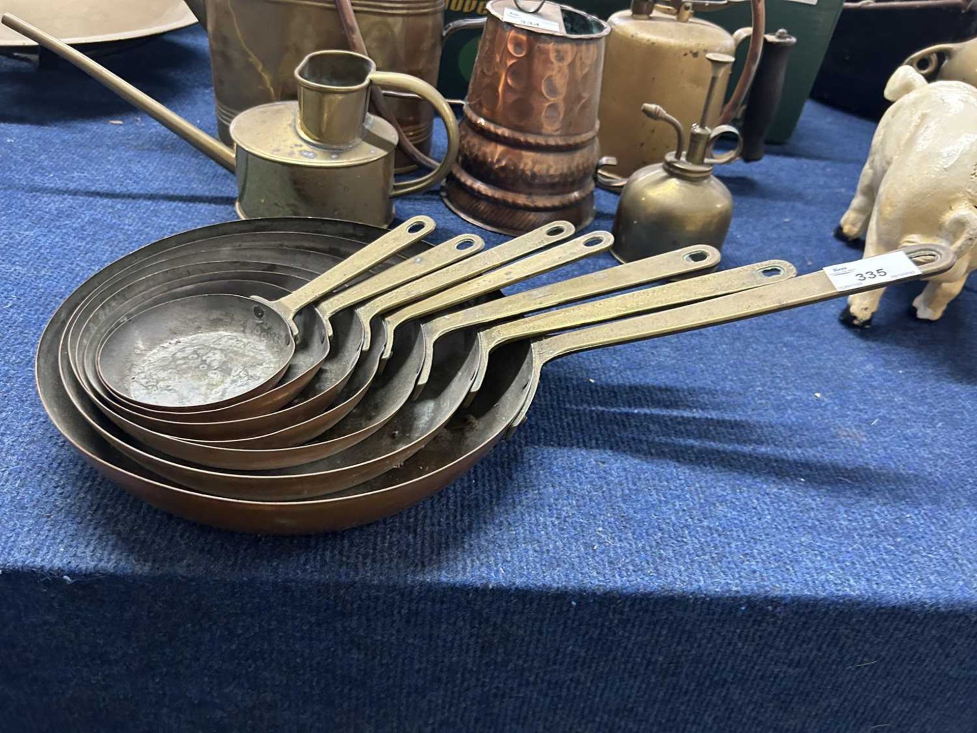 Graduated set of copper and brass handled saucepans