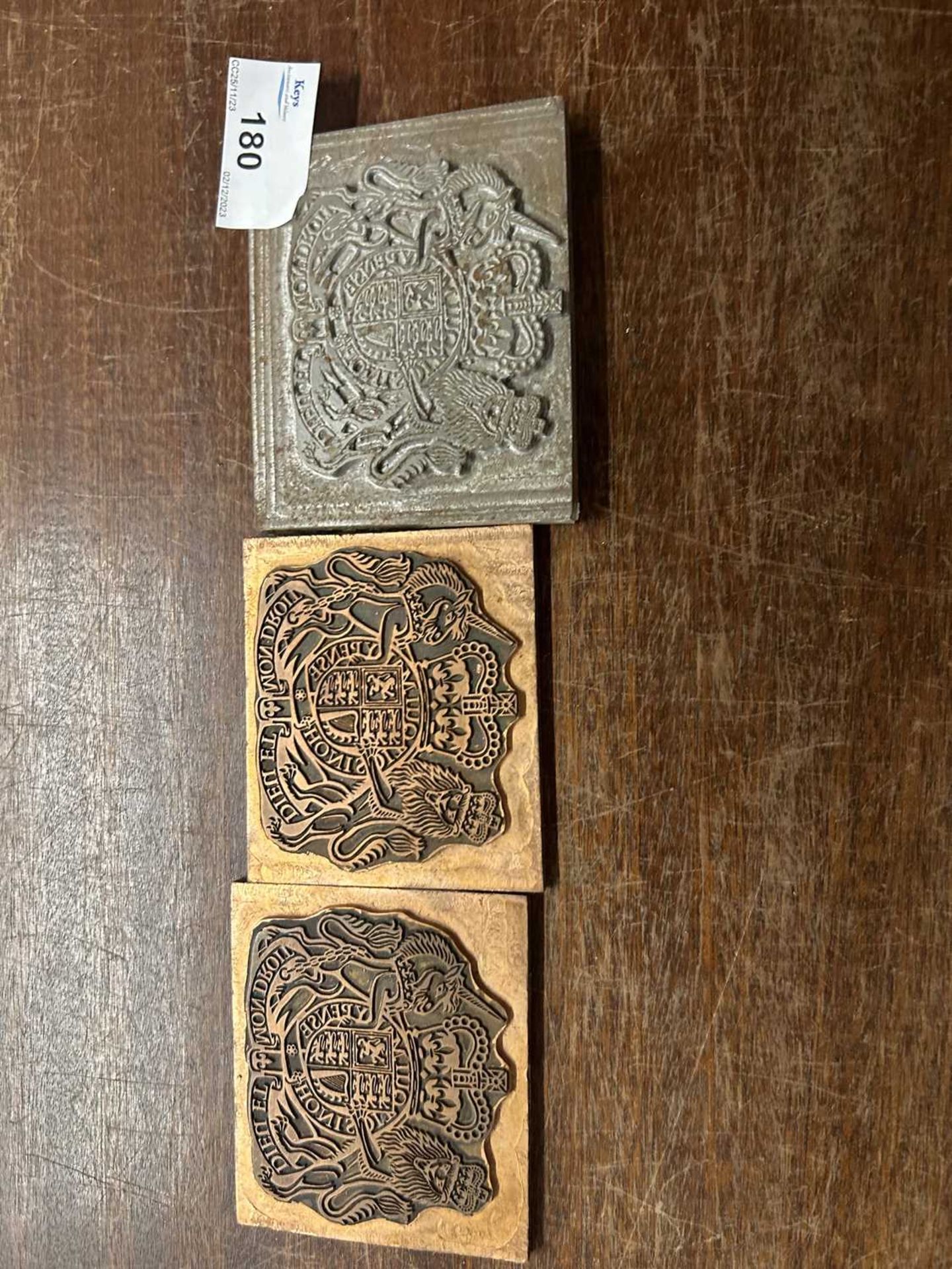 Three small printing blocks decorated with Royal Coat of Arms