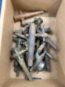 A box of various wood, brass and other barrel taps