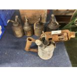 Four vintage oil cans and a blow torch