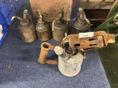 Four vintage oil cans and a blow torch