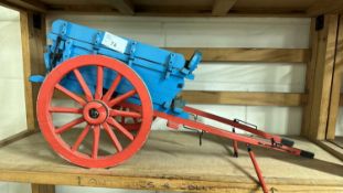 A scratch built model of a single axle farm cart painted in blue and red, approx 50cm long in total