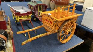 A scratch built model of a single axle hay cart, painted in dark yellow and black, 65cm long in