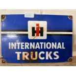 A reproduction enamel sign for "International Trucks"