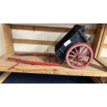 A scratch built model of a single axle cart painted in red and blue, approx 50cm long