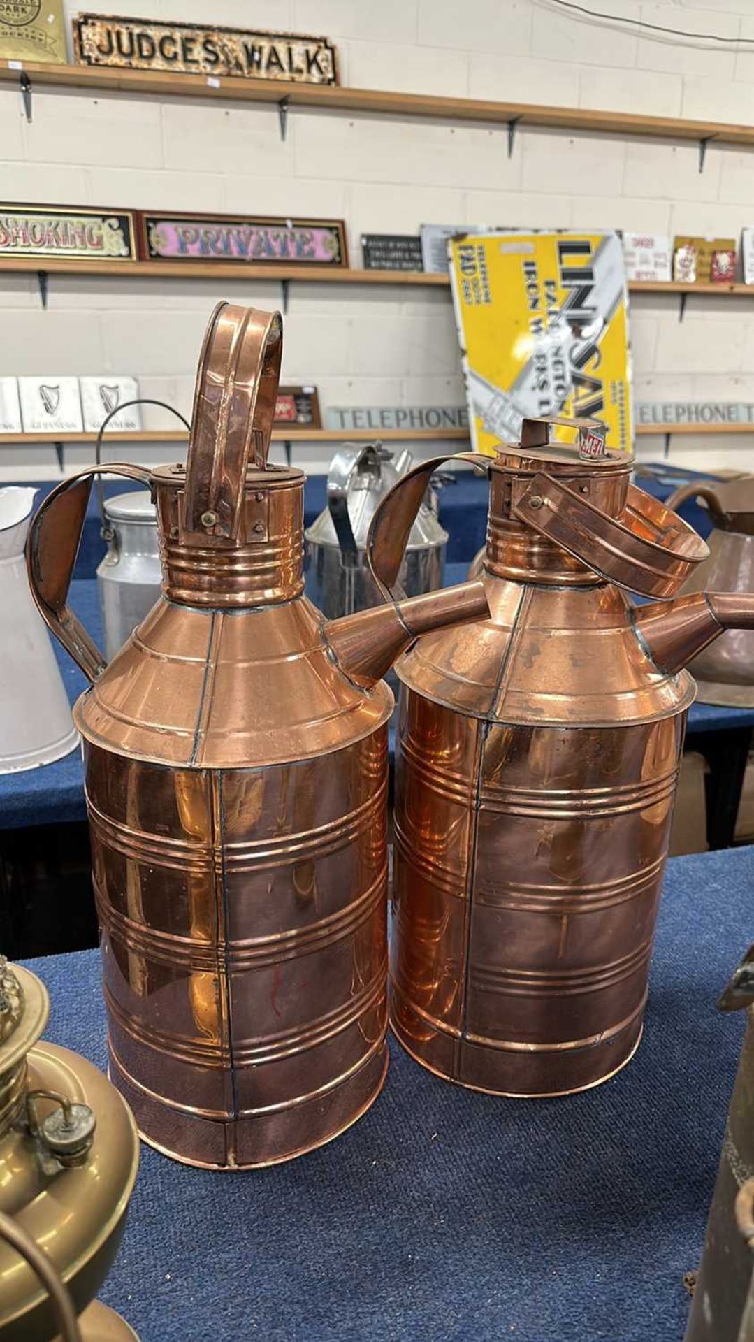 A pair of large copper single handled jugs, probably reproductions