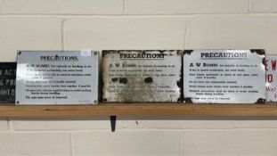 Three enamelled "A W Bombs Precautions" notices