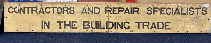 Sheet metal sign on wooden back marked Contracts and Repair Specialists in the Building Trade, 141cm