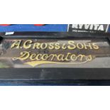A framed wooden sign with raised lettering marked A.Cross & Sons Decorators, 60cm wide