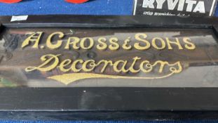 A framed wooden sign with raised lettering marked A.Cross & Sons Decorators, 60cm wide
