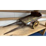 A scratch built model of a single axle flat topped cart with painted decoration, 48cm long