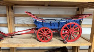 A scratch built model of a Monmouthshire cart, painted in red and blue, approx 75cm long in total