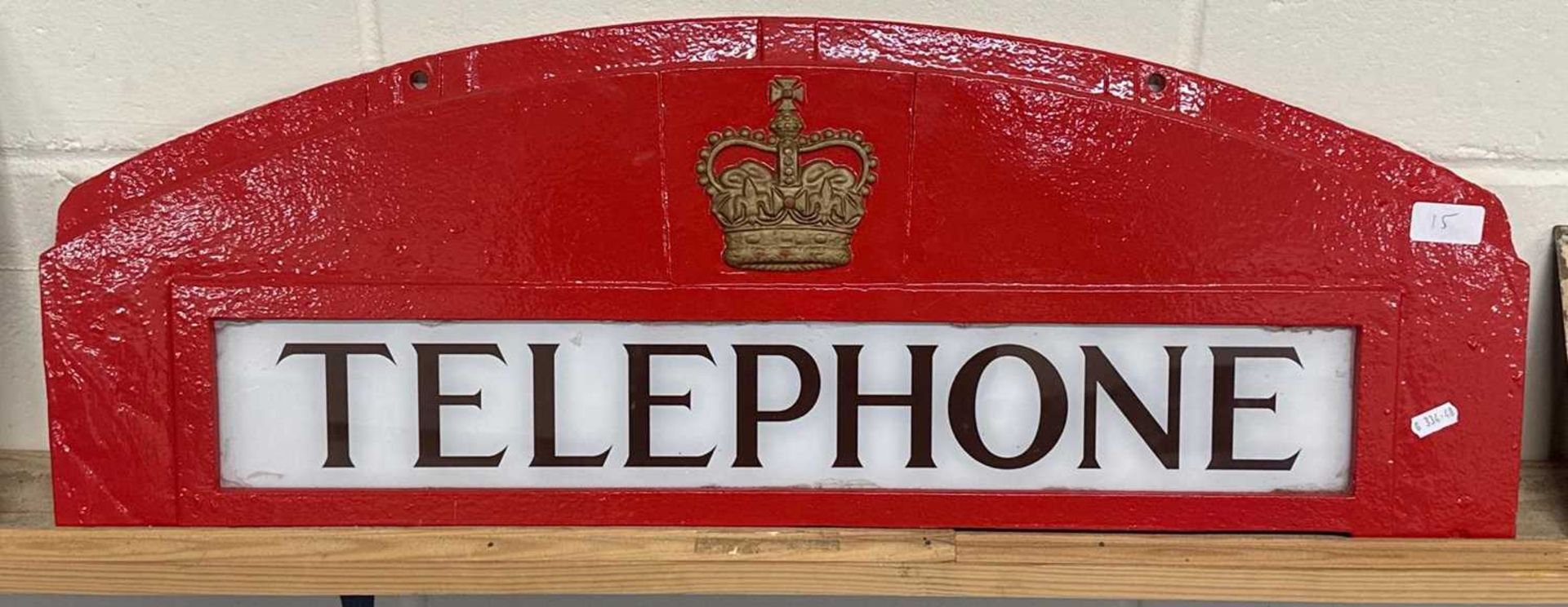 A cast "Telephone" sign from a telephone box