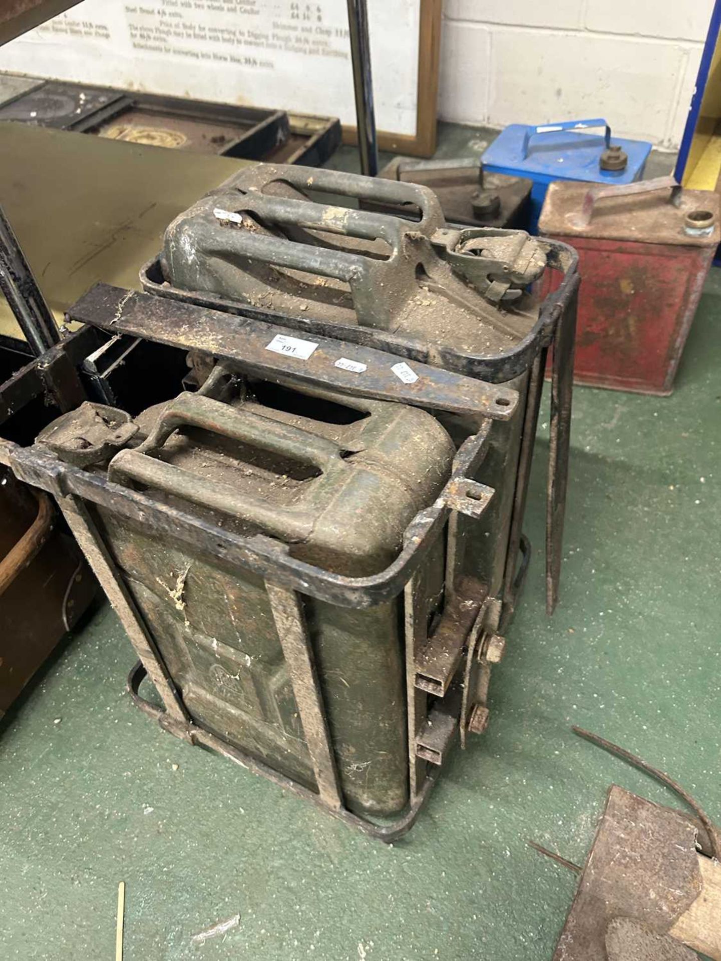 Two vintage jerry cans with transport cages