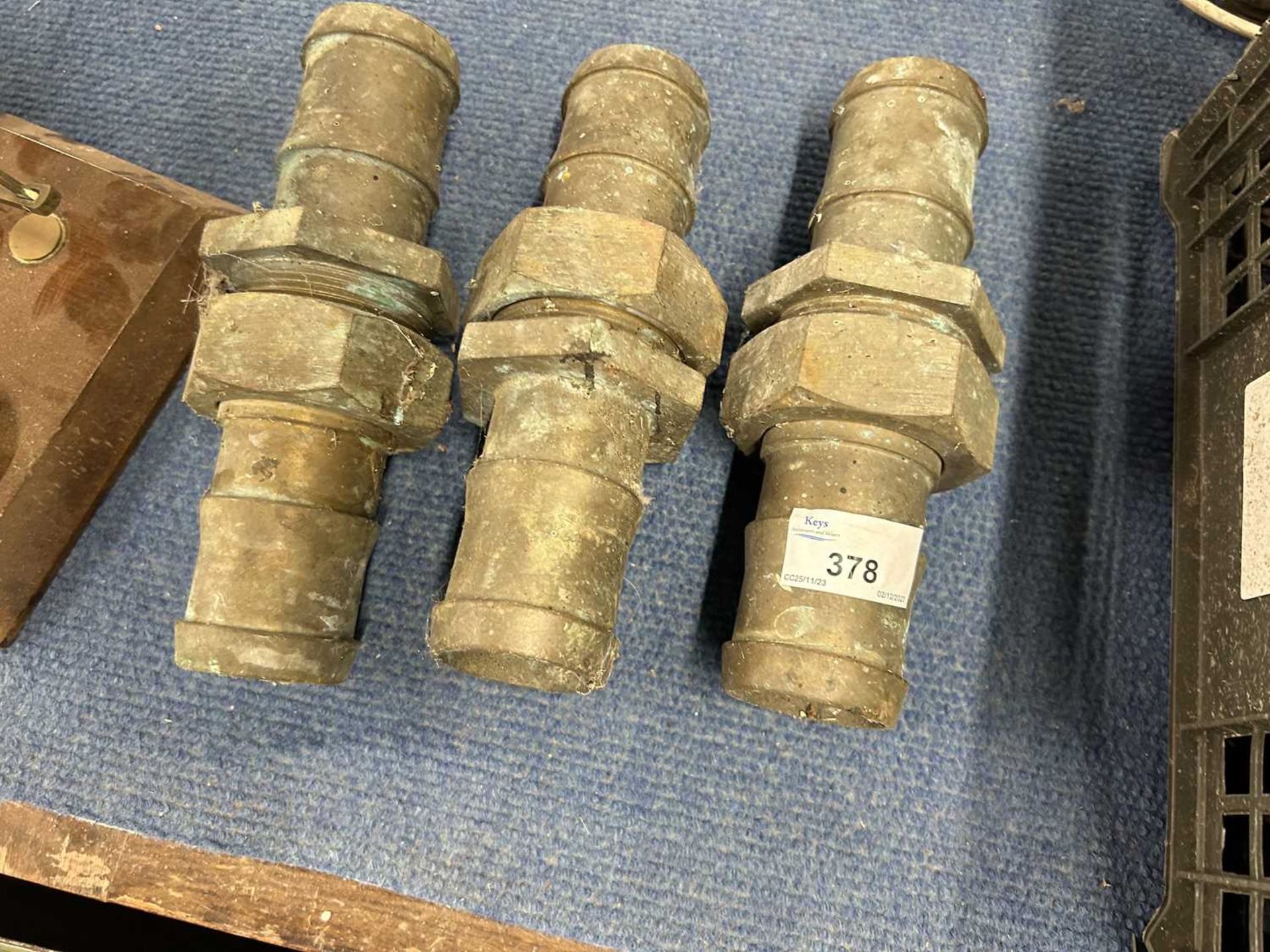Three large threaded brass pipe connectors