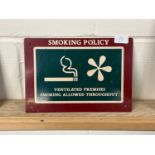 A metal "Smoking Policy" sign