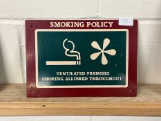 A metal "Smoking Policy" sign