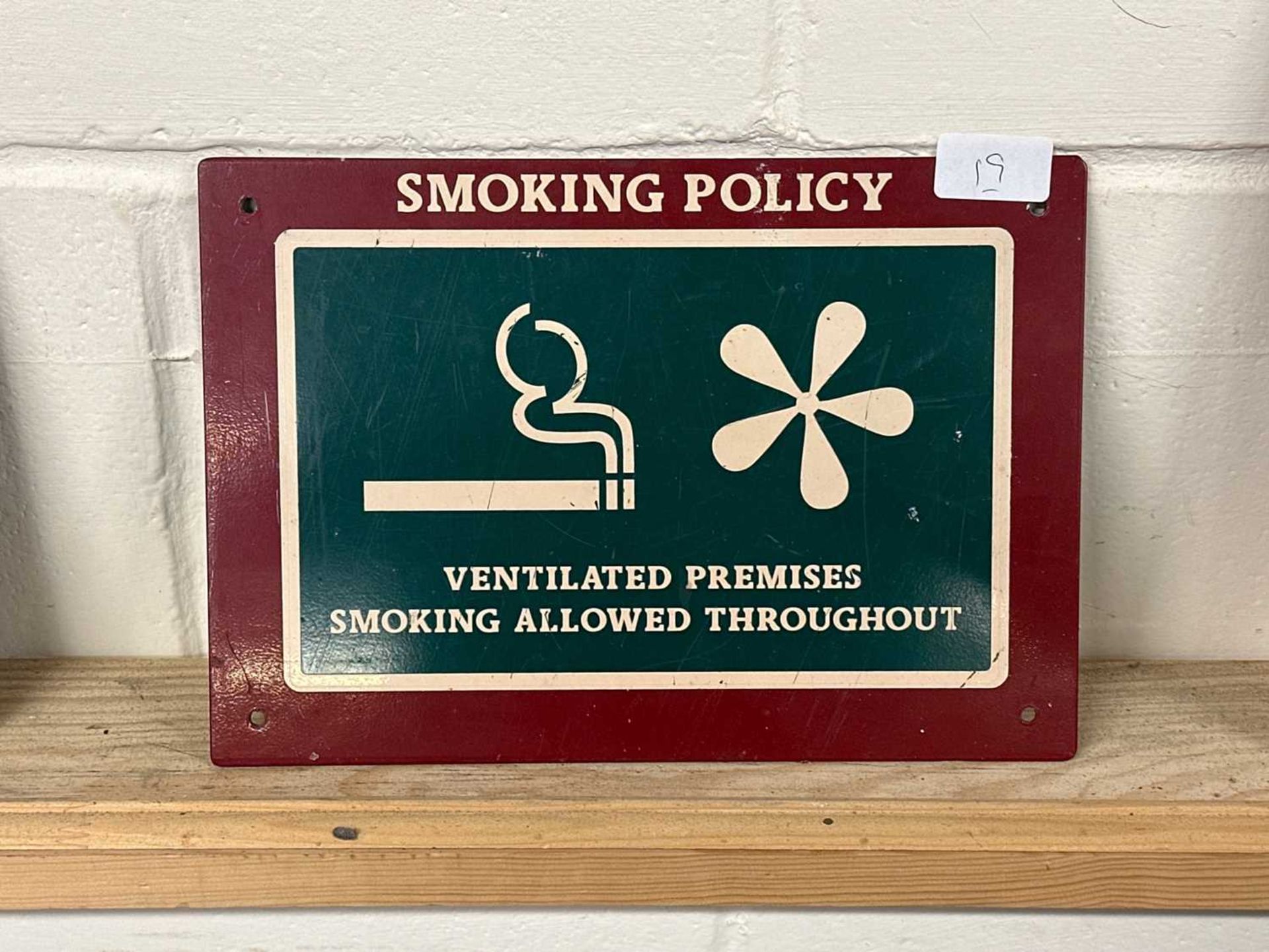 A metal "Smoking Policy" sign