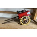 A scratch built model of a small single axle cart, painted in red and yellow, approx 34cm long