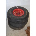 Three small trailer wheels with tyres