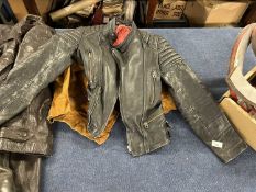 Vintage dark leather motorcycle jacket together with a further suede jacket