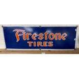 A reproduction metal sign for "Firestone Tires"