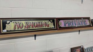 Two mirrored pub signs "No Smoking" and "Private", both framed