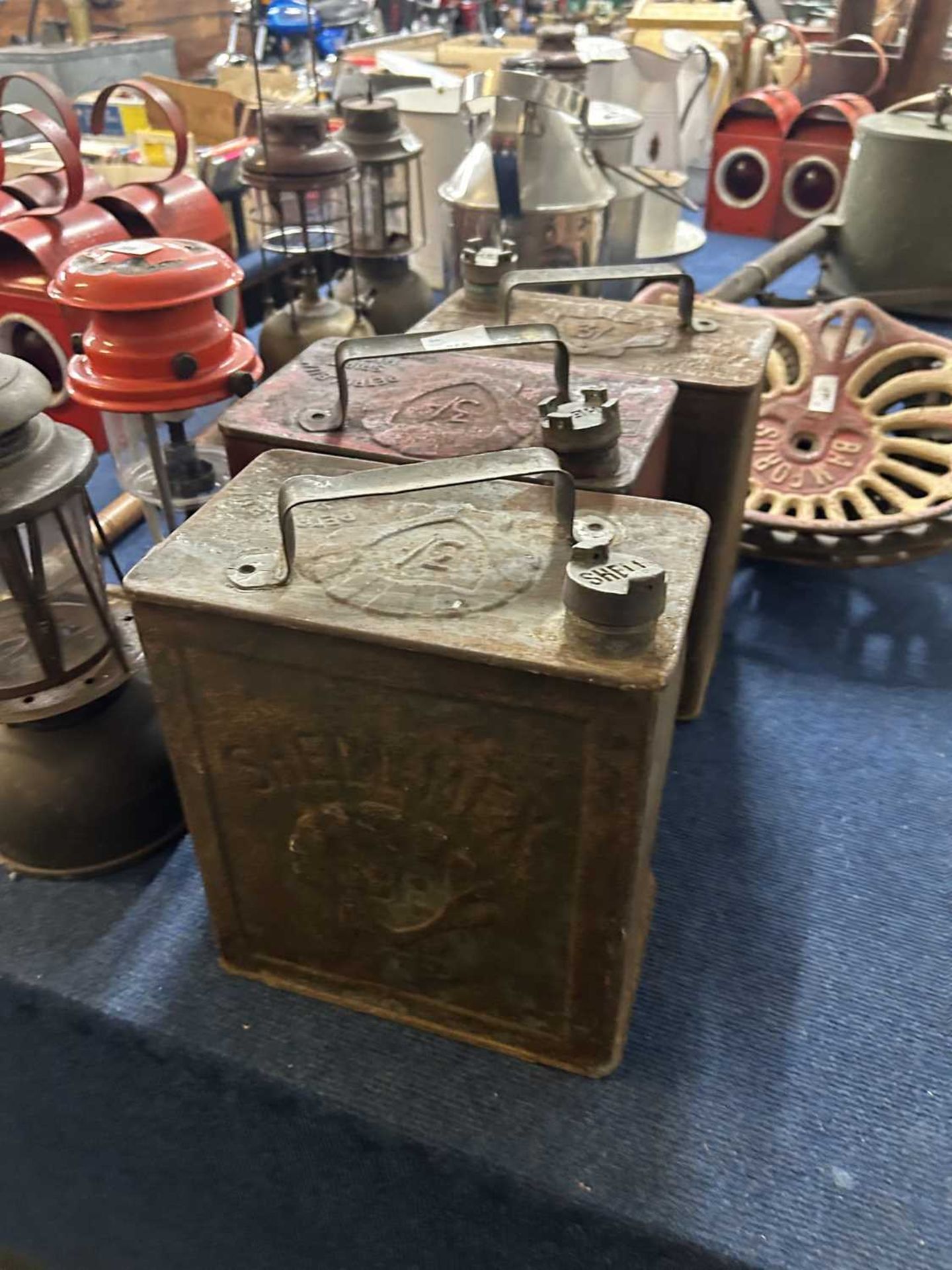 Three vintage petrol cans, two marked 'Shellmex', the other marked 'Shell Motor Spirit'