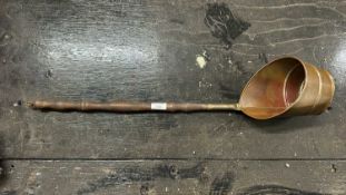 A copper long handled pan